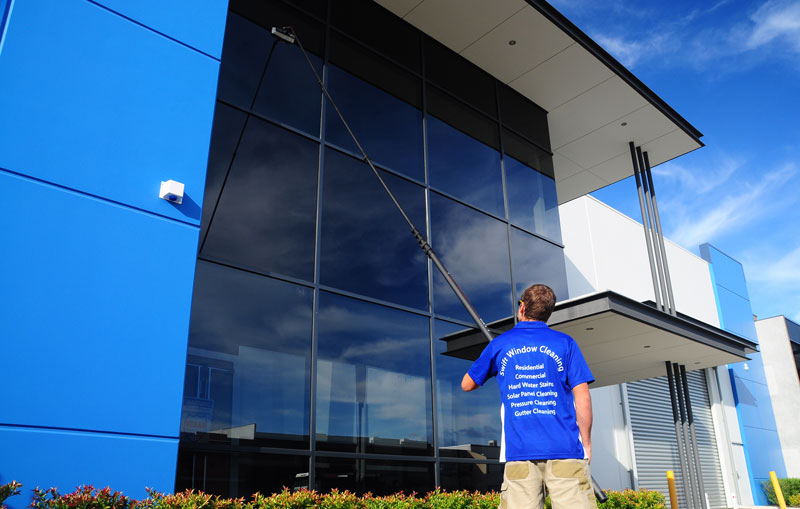 Window cleaner using pure water fed pole system on a multi-storey commercial building in canningvale