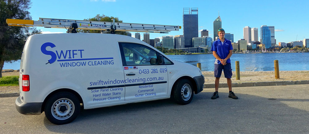 Swift window cleaning company van infront of Perth city with business owner standing near van